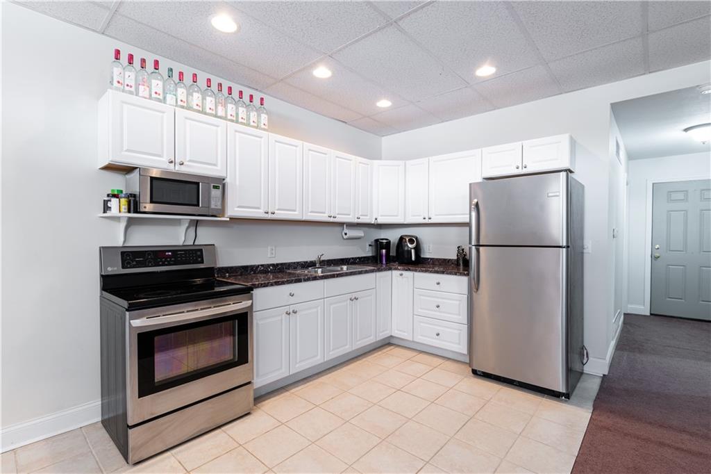 177 Bryson Road Gibsonia, PA 15044 - Photo 11 of 17 a kitchen with granite countertop a refrigerator stove and microwave