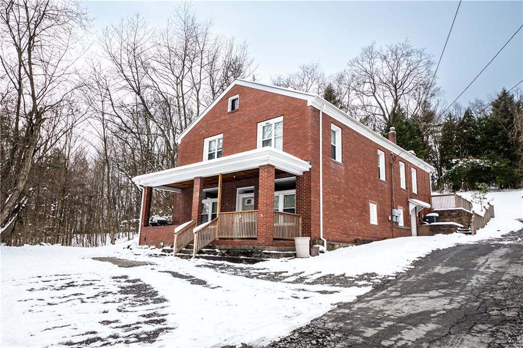 177 Bryson Road Gibsonia, PA 15044 - Photo 2 of 17 a front view of a house with a yard covered in snow