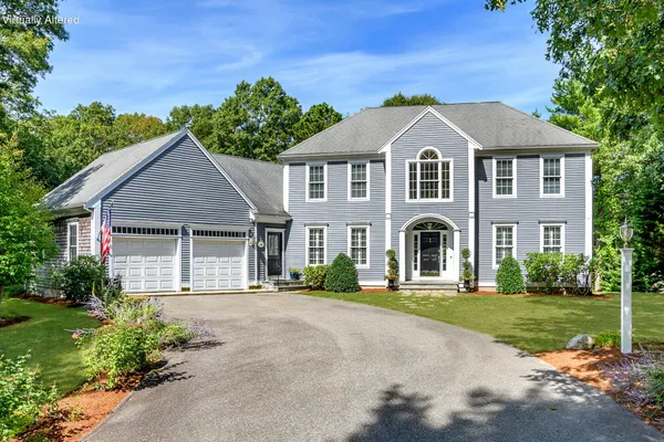 a front view of a house with a garden