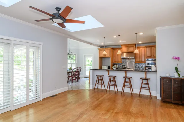 a view of a a dining room with furniture window and wooden floor