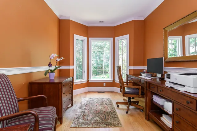 a view of a workspace with furniture and a window