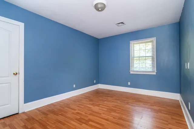 a bathroom with a granite countertop toilet a sink and a mirror