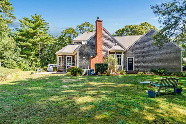 a view of a backyard with sitting area and garden