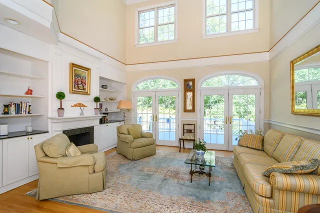 a living room with furniture fireplace and a large window