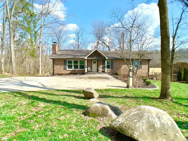 a view of a house with swimming pool and a garden