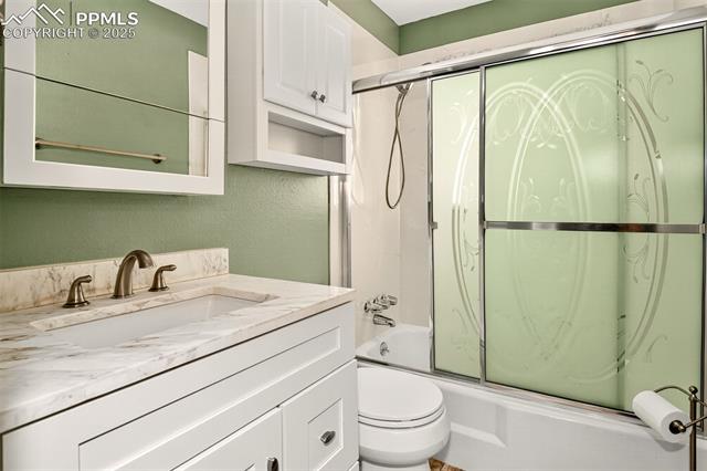 6723 Seneca Road Colorado Springs, CO 80915 - Photo 14 of 36 Main level full bathroom with quartz vanity and tub/shower combo