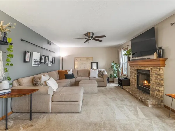 a kitchen with stainless steel appliances granite countertop wooden cabinets a stove a sink a oven with a dining table and chairs