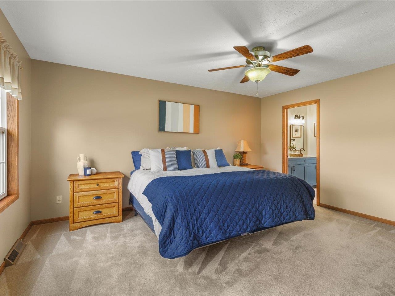 8027 Barclay Road Rockford, IL 61102 - Photo 27 of 67 a bedroom with a bed and a chandelier