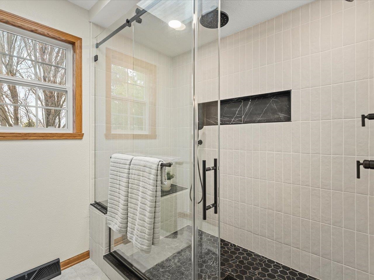 8027 Barclay Road Rockford, IL 61102 - Photo 31 of 67 a bathroom with a shower and a window