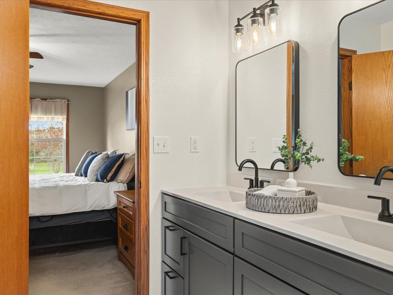 8027 Barclay Road Rockford, IL 61102 - Photo 33 of 67 a bathroom with a granite countertop sink and a mirror