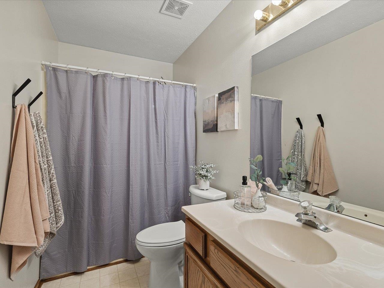 8027 Barclay Road Rockford, IL 61102 - Photo 38 of 67 a bathroom with a sink a toilet and a mirror