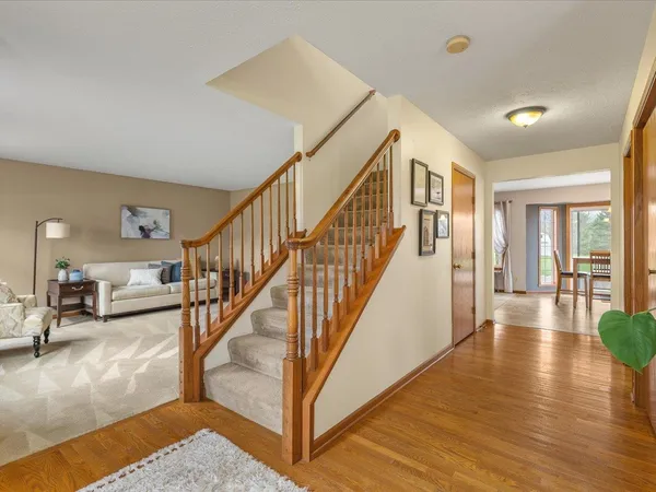 a view of staircase with lots of frames on wall and windows