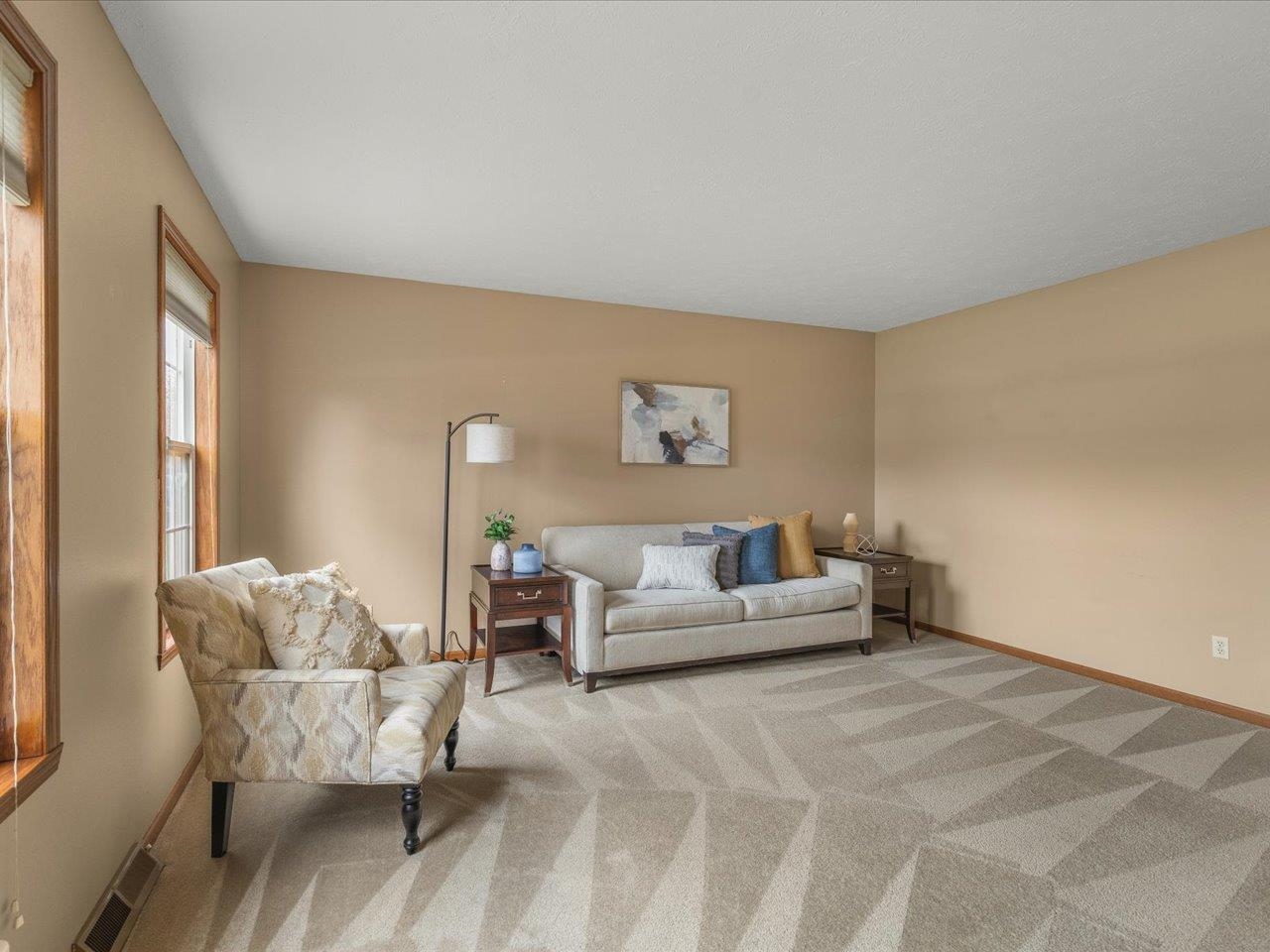 8027 Barclay Road Rockford, IL 61102 - Photo 9 of 67 a living room with furniture and a large window