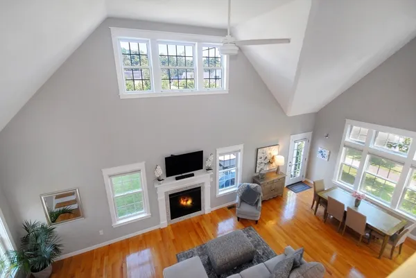 a living room with furniture a fireplace and a flat screen tv