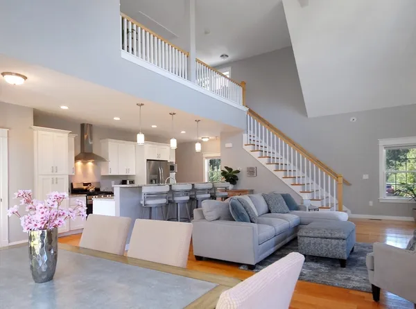 a living room with furniture and kitchen view