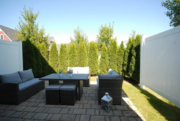 a view of a balcony with chairs and a potted plant
