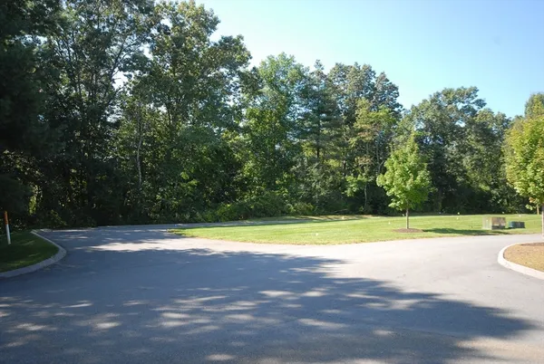 a view of a swimming pool and a yard