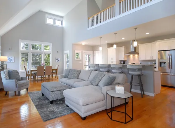 a living room with furniture and kitchen view