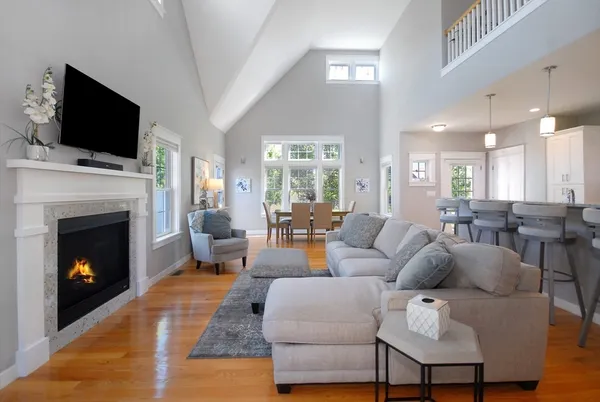 a living room with furniture a fireplace and a flat screen tv