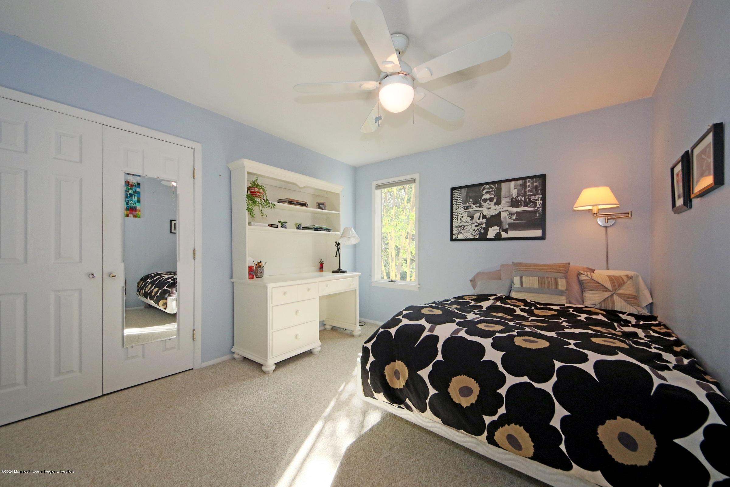 18 Daniel Drive Little Silver, NJ 07739 - Photo 36 of 55 a bedroom with a bed and a chandelier