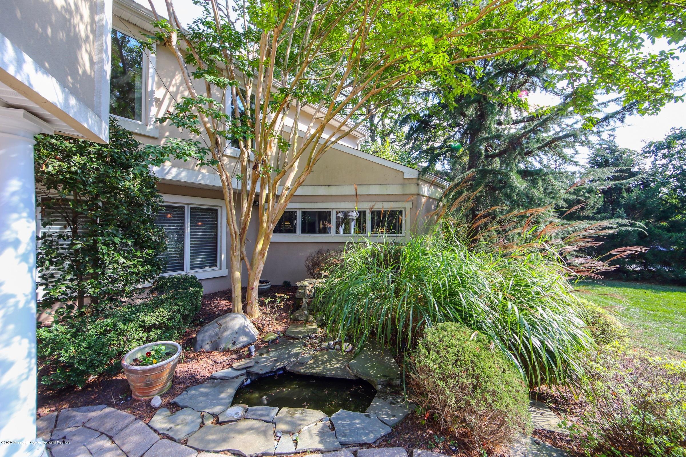 18 Daniel Drive Little Silver, NJ 07739 - Photo 5 of 55 a front view of a house with a yard and potted plants