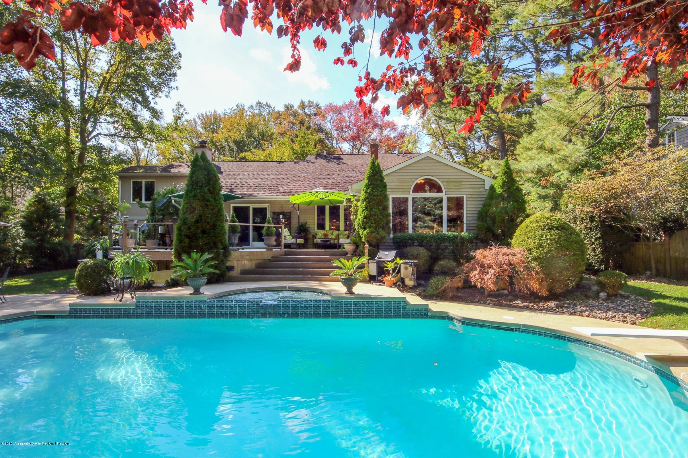 18 Daniel Drive Little Silver, NJ 07739 - Photo 43 of 55 a front view of a house with a garden and trees