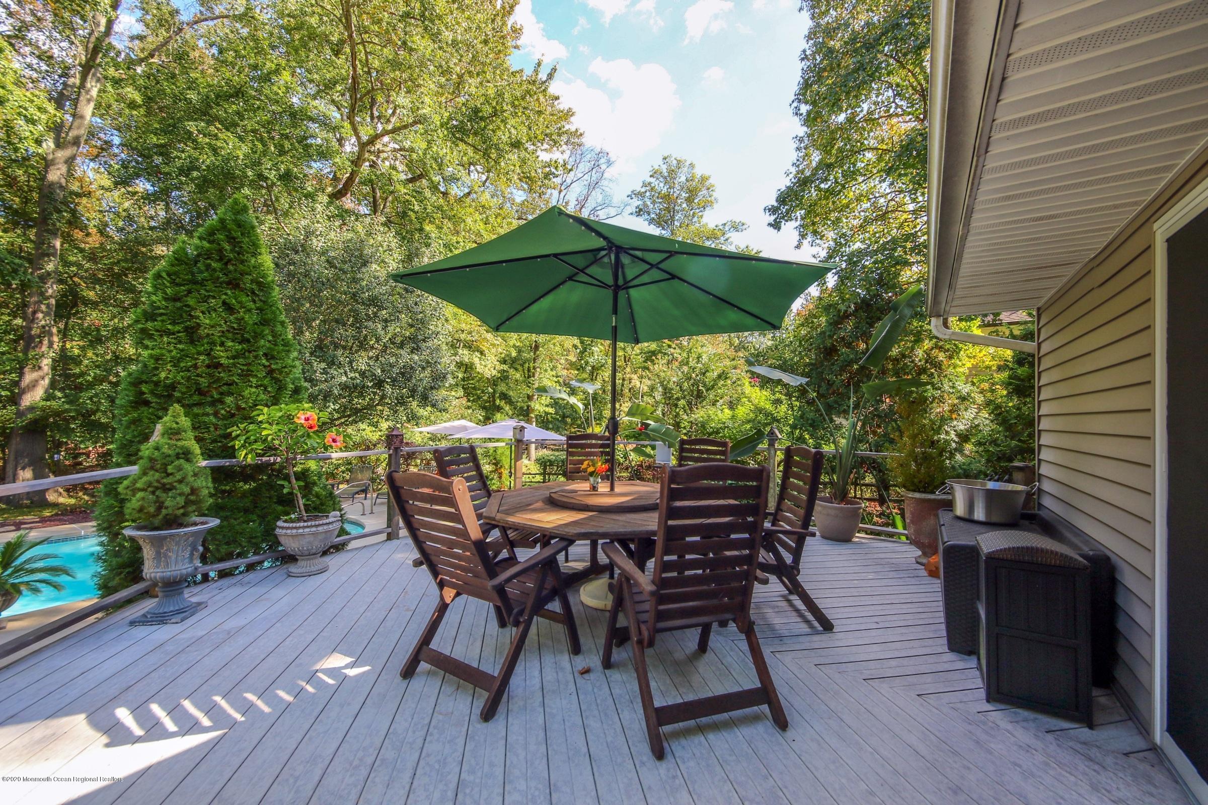 18 Daniel Drive Little Silver, NJ 07739 - Photo 53 of 55 a view of patio with table and chairs under an umbrella