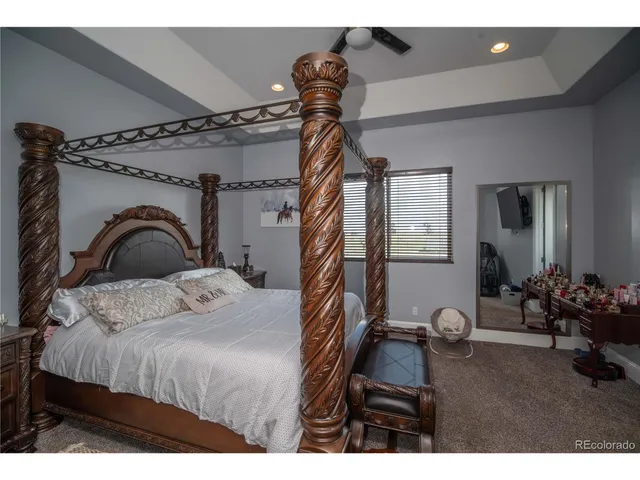 a bedroom with a bed and a dresser next to a window