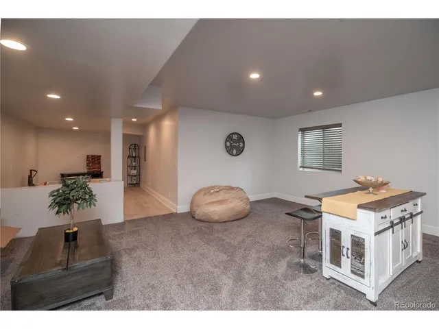 a kitchen with furniture and a potted plant