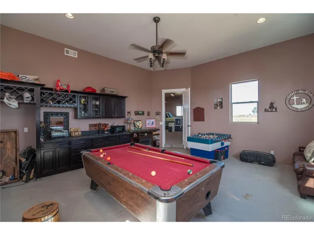 a room with pool table and flat screen tv