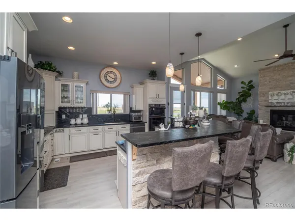 a large kitchen with a table and chairs