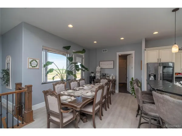 a view of a dining room with furniture and window