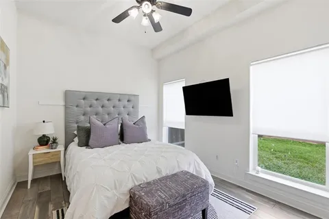 a bedroom with a bed and a flat screen tv