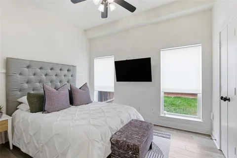 a bedroom with a bed and a television