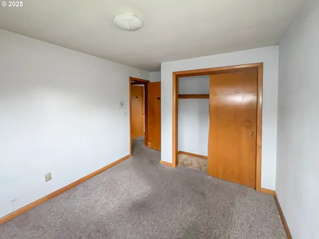 a view of an empty room and closet
