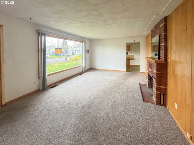 a view of empty room with floor to ceiling window