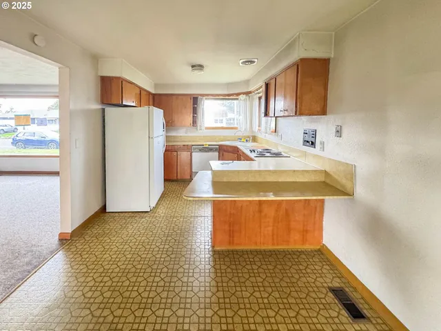 a view of a kitchen with a sink cabinets and a refrigerator