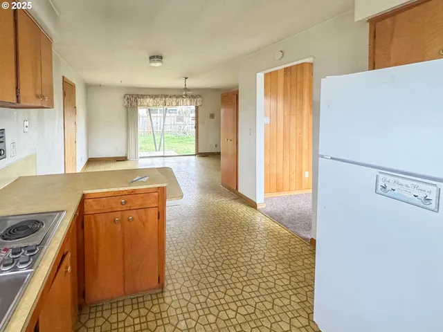 a kitchen with a refrigerator stove and a sink