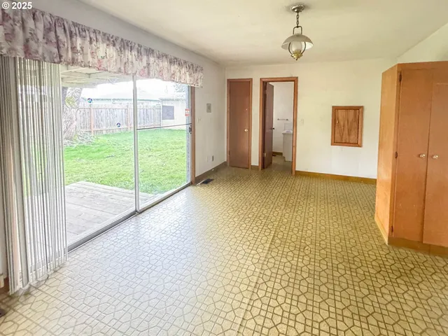 a view of empty room with floor to ceiling window