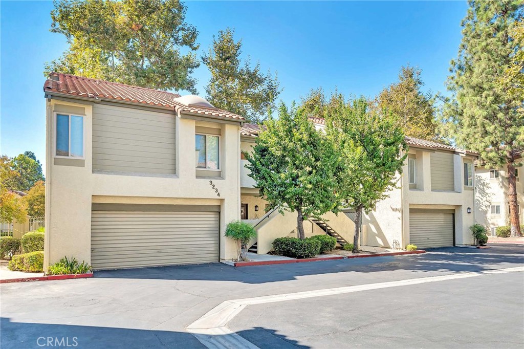 3234 Darby Street, Unit 228 Simi Valley, CA 93063 - Photo 1 of 1 a front view of a house with a yard and garage