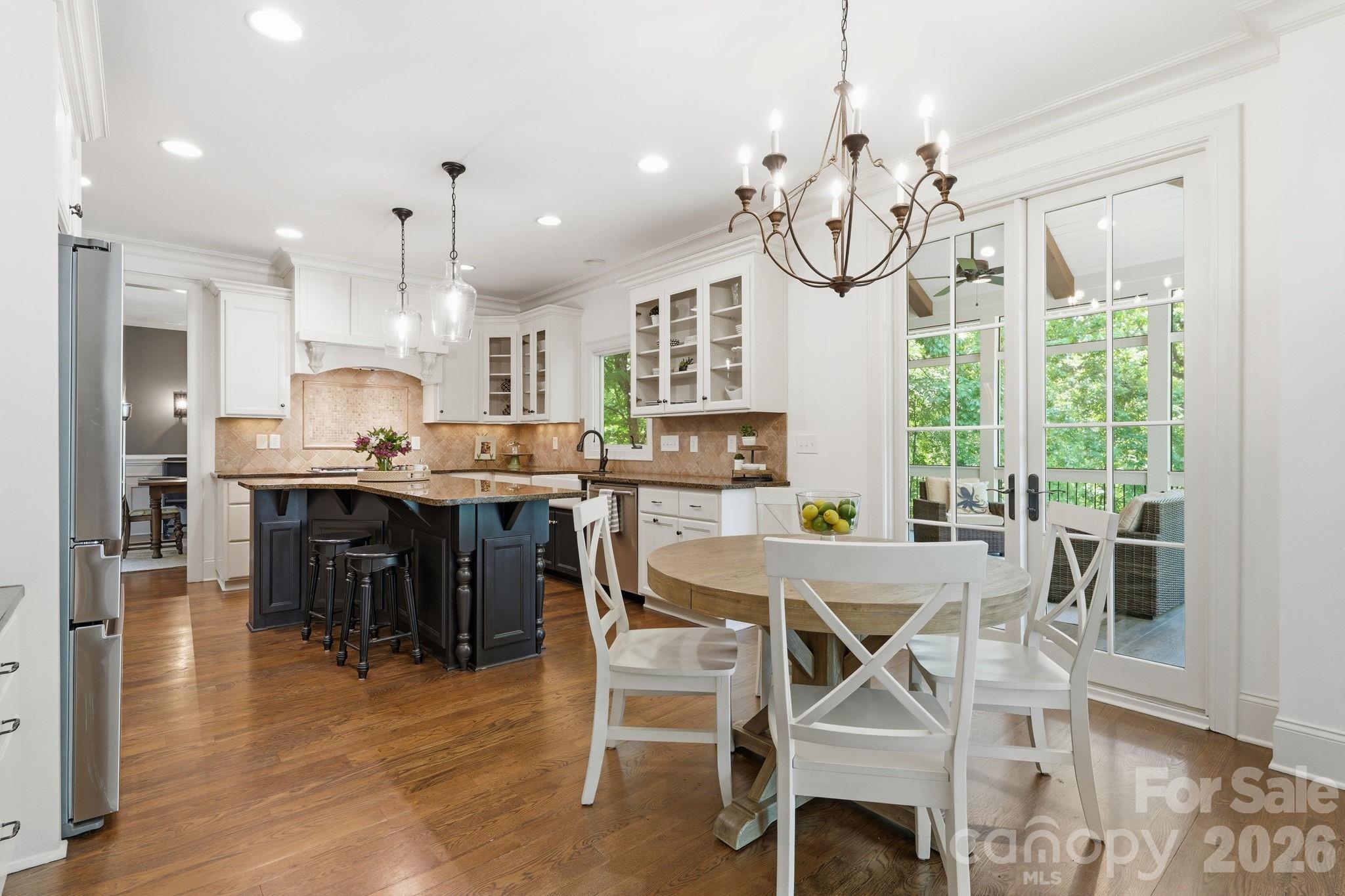 235 Grey Road Davidson, NC 28036 - Photo 8 of 42 a view of a dining room and livingroom with furniture wooden floor a chandelier