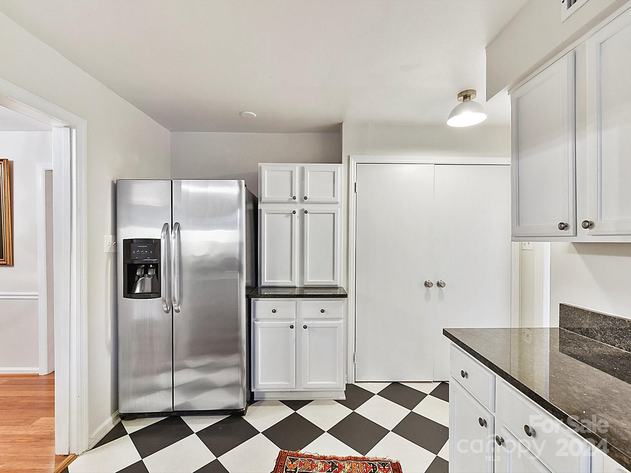 1708 Roxborough Road, Unit E Charlotte, NC 28211 - Photo 13 of 20 a kitchen with granite countertop stainless steel appliances a sink and cabinets
