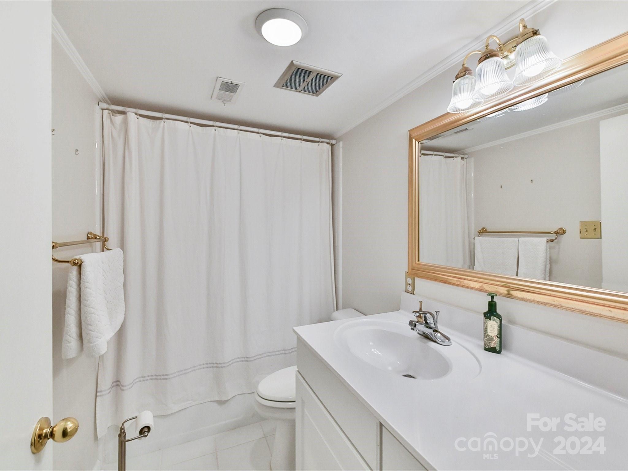 1708 Roxborough Road, Unit E Charlotte, NC 28211 - Photo 15 of 20 a bathroom with a sink toilet and shower