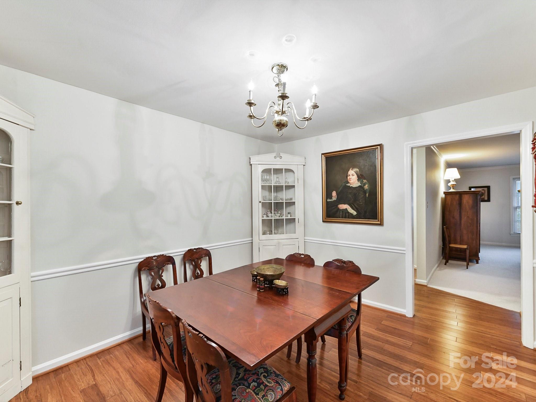 1708 Roxborough Road, Unit E Charlotte, NC 28211 - Photo 16 of 20 a view of a dining room with furniture and wooden floor