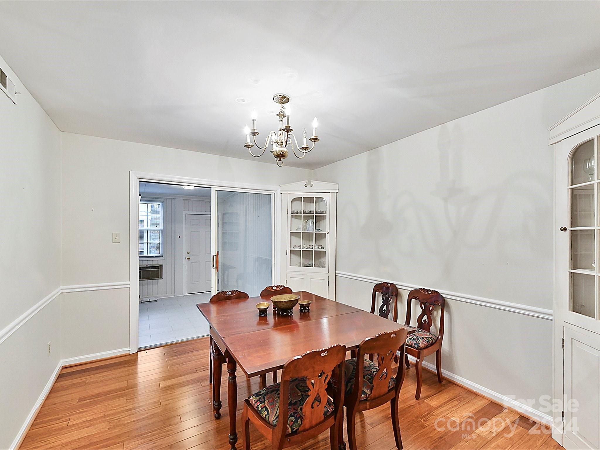 1708 Roxborough Road, Unit E Charlotte, NC 28211 - Photo 17 of 20 a view of a dining room with furniture and wooden floor