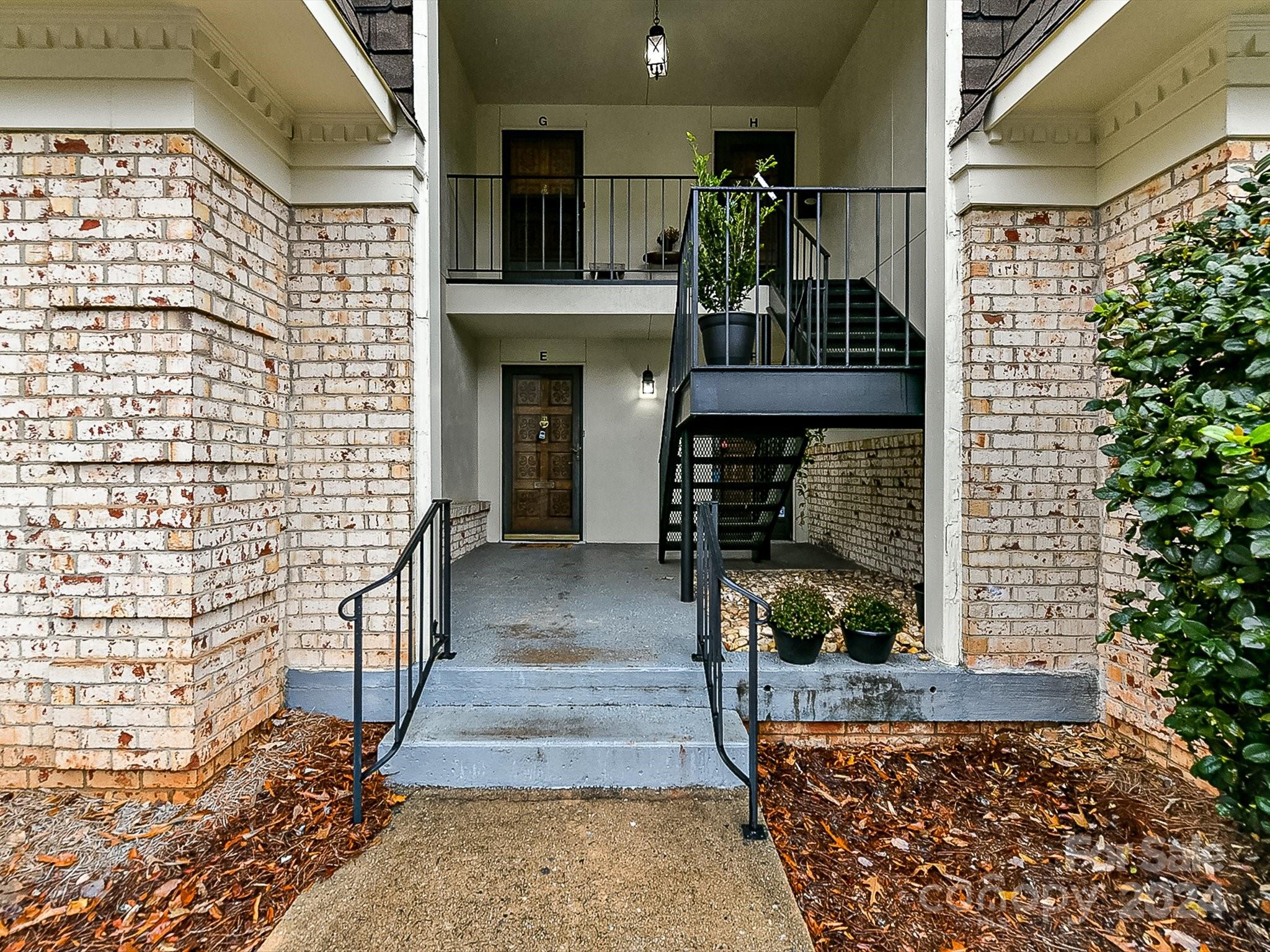 1708 Roxborough Road, Unit E Charlotte, NC 28211 - Photo 3 of 20 a front view of a house with a garden