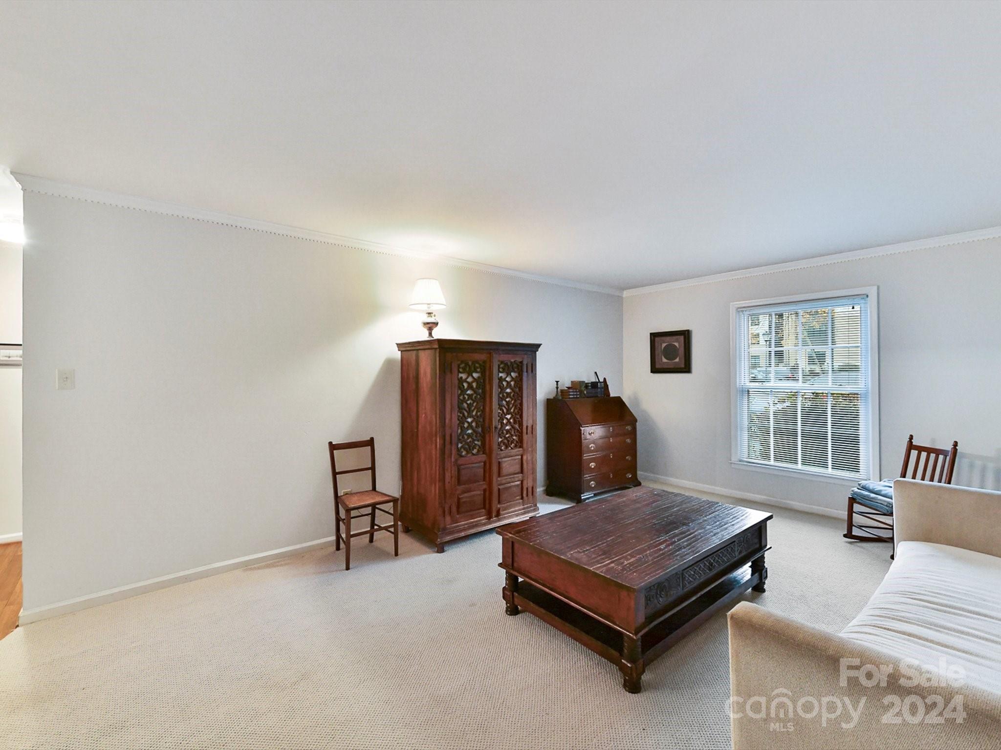 1708 Roxborough Road, Unit E Charlotte, NC 28211 - Photo 6 of 20 a living room with furniture rug and window