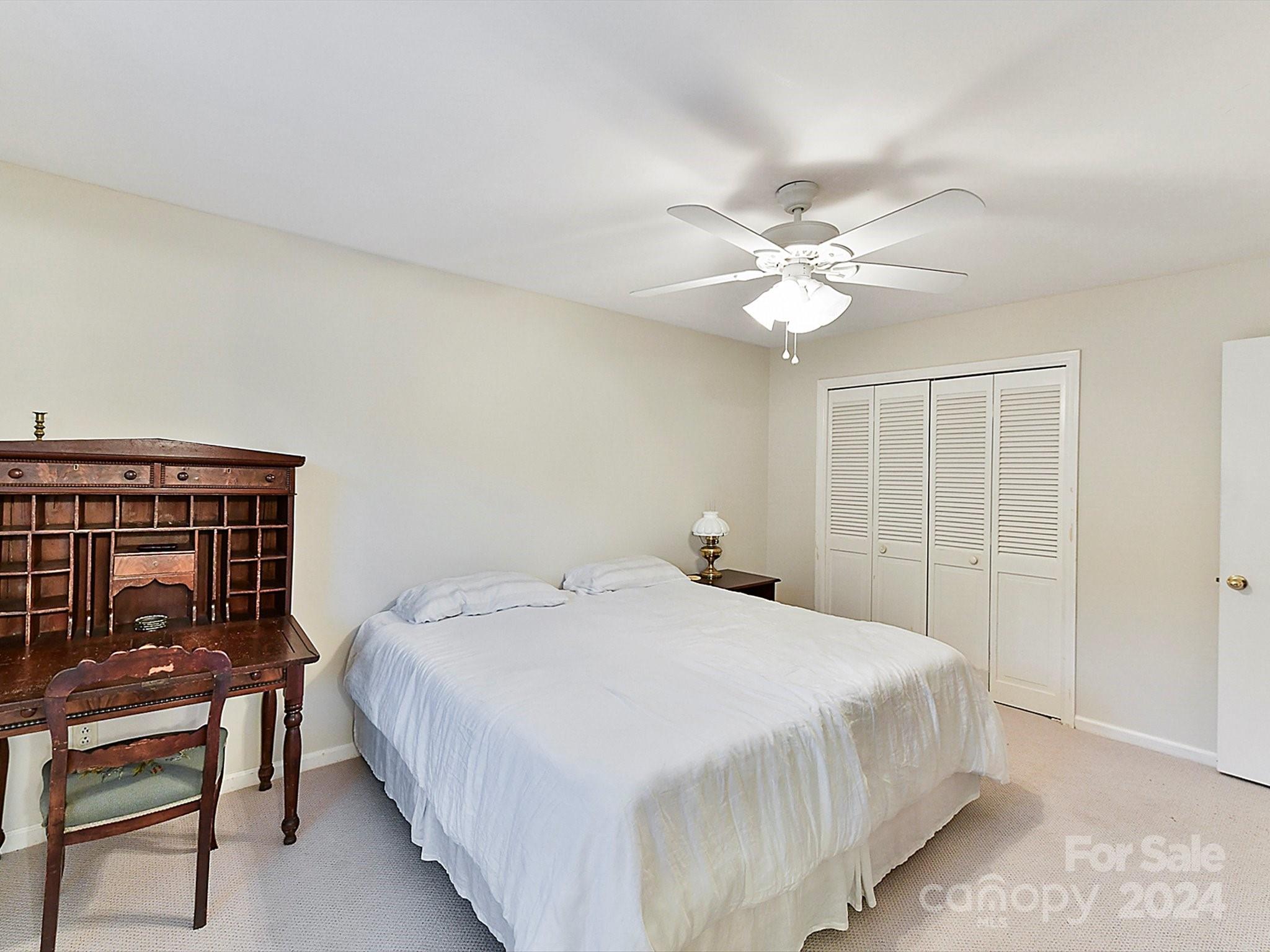 1708 Roxborough Road, Unit E Charlotte, NC 28211 - Photo 8 of 20 a bedroom with a bed and a chandelier