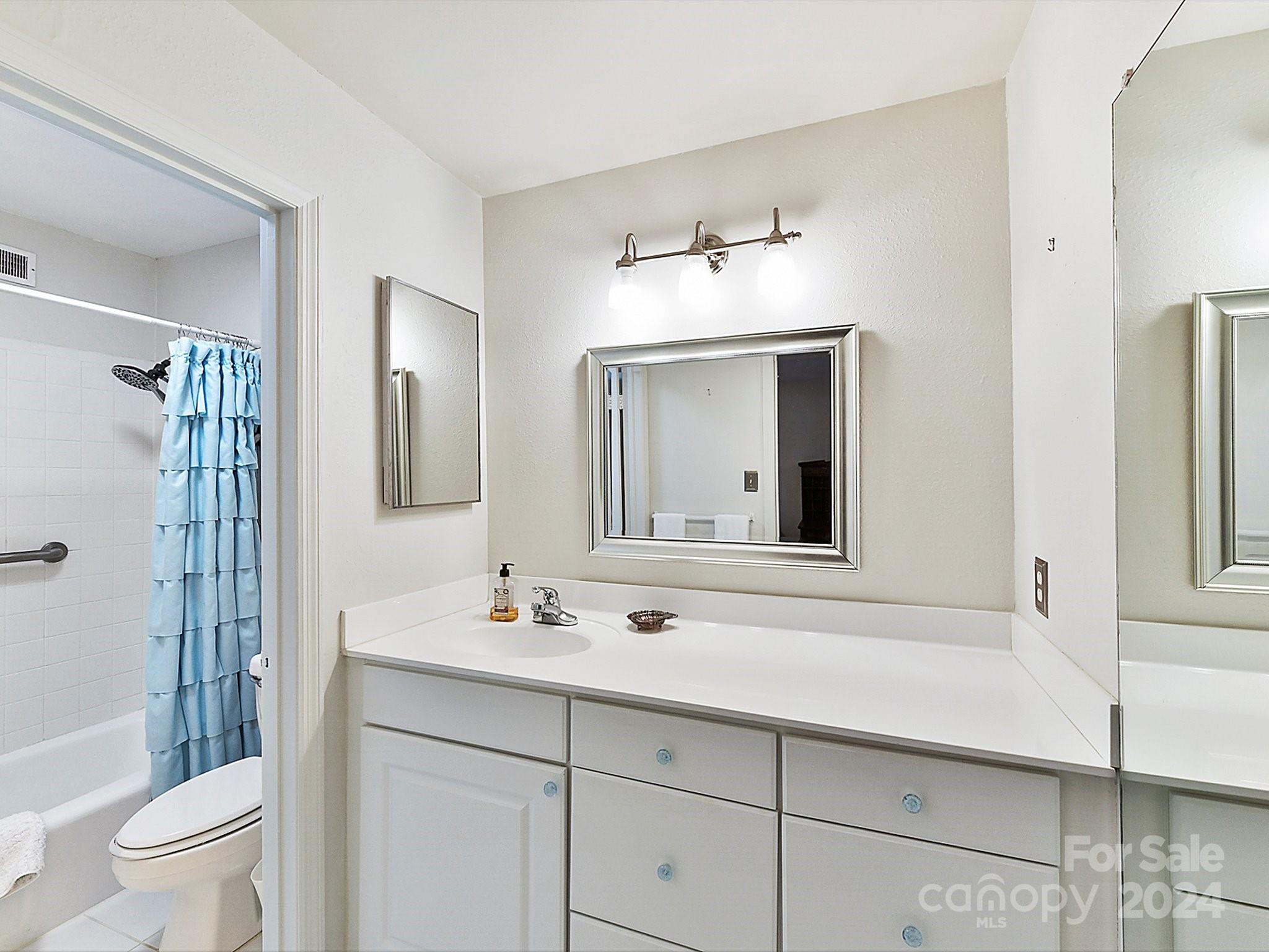1708 Roxborough Road, Unit E Charlotte, NC 28211 - Photo 10 of 20 a bathroom with a sink a toilet and shower