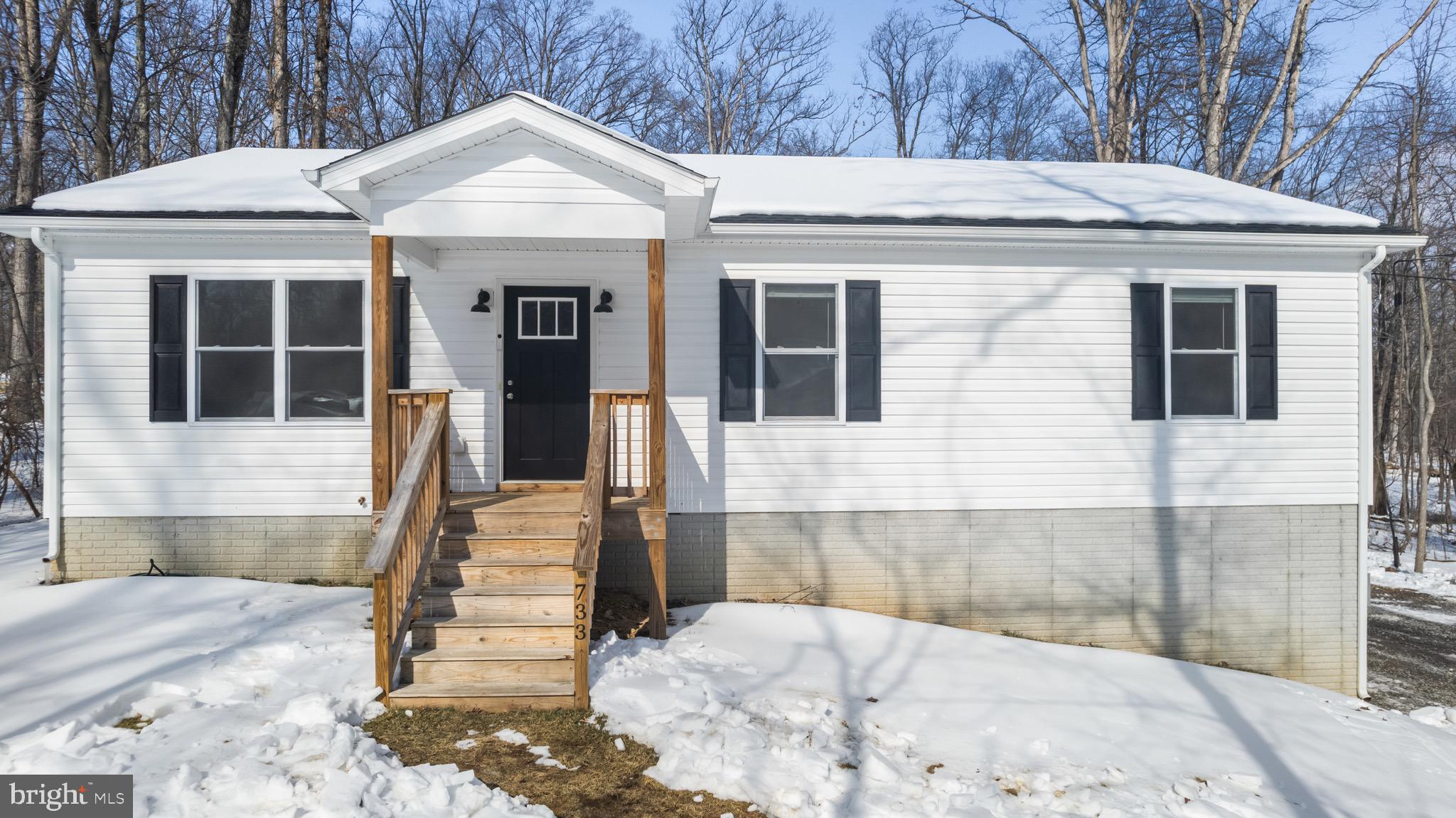 733 Red Bird Lane Harpers Ferry, WV 25425 - Photo 1 of 29 a front view of a house with a garden